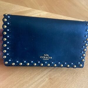 Black coach purse- gold and silver detail. barley used. Great condition